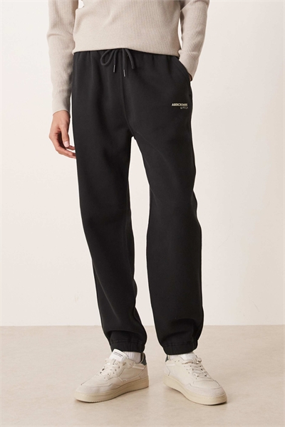 Джоггеры с логотипом и свободными манжетами артикул 155057892