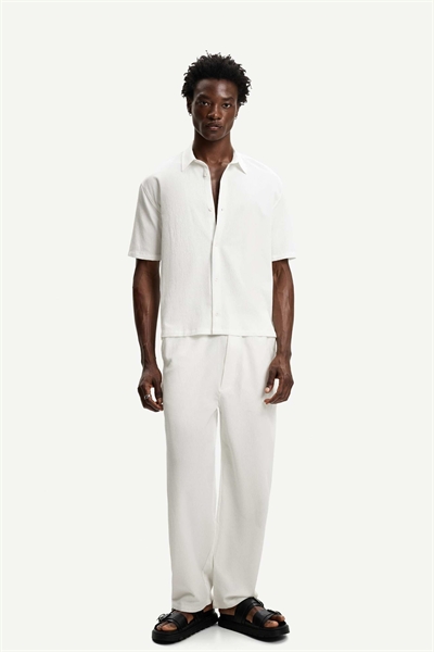 Брюки-джоггеры свободного кроя с плиссировкой артикул 149859724