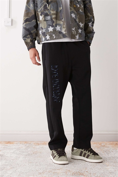 Джоггеры Aape by A Bathing Ape свободного кроя черного цвета с вышивкой на штанинах артикул 150152321