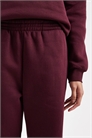Комплект из джоггеров с широкими манжетами бордового цвета артикул 150747256
